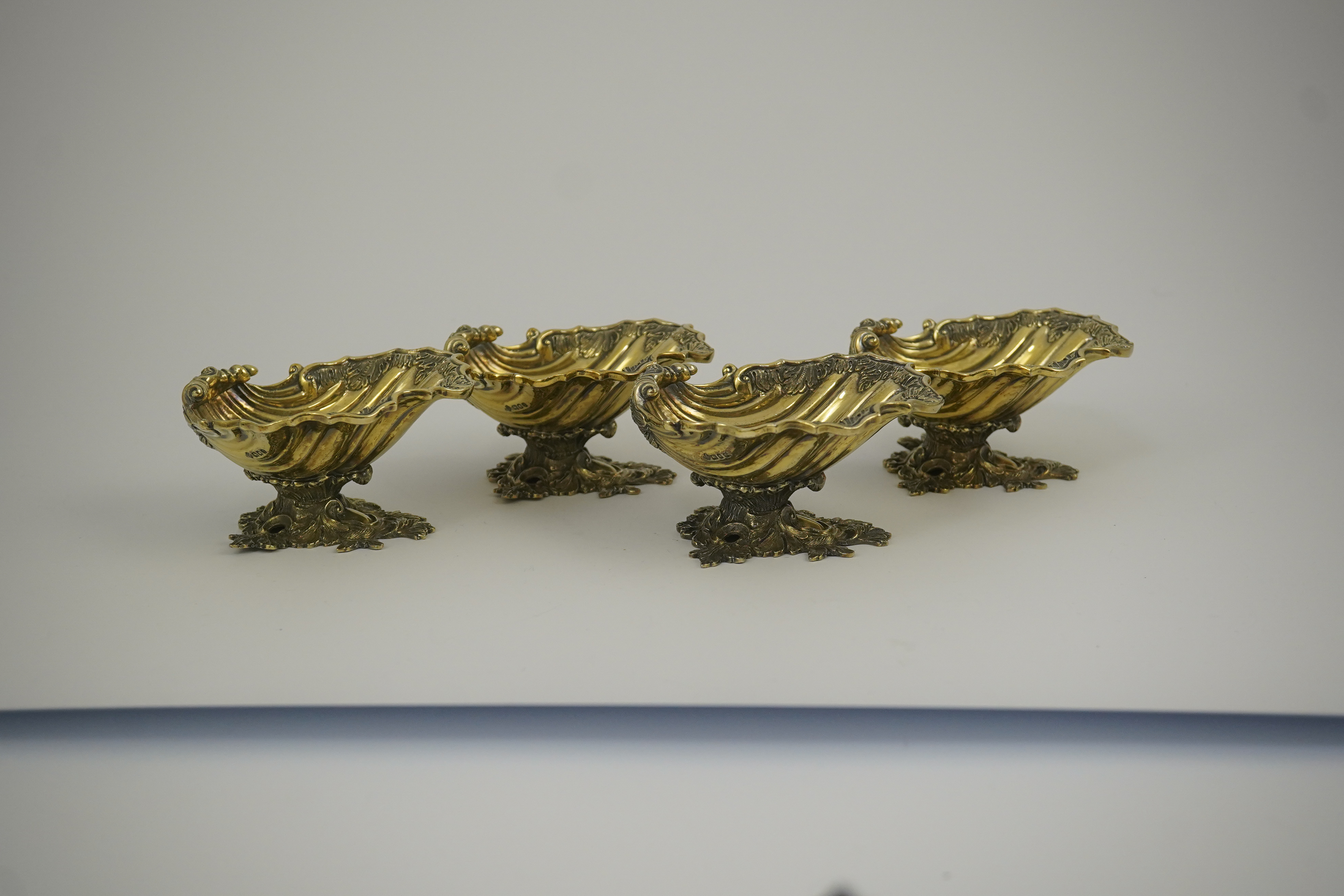 A set of Elizabeth II Victorian style silver gilt pedestal shell salts, by Asprey & Co Ltd